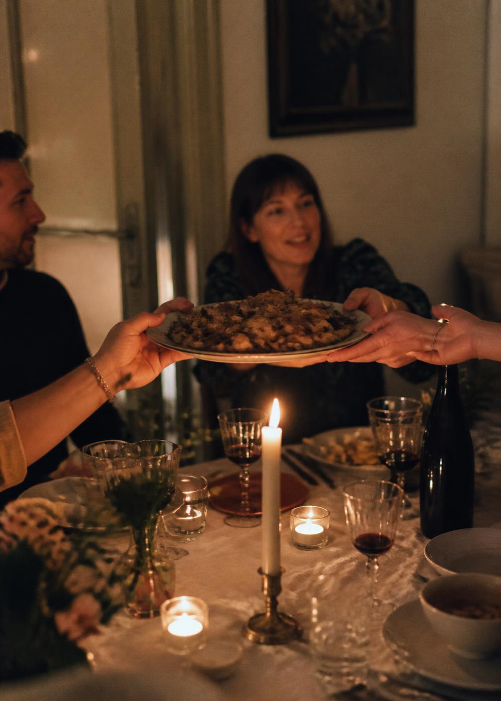 A platter passed across a candlelit table